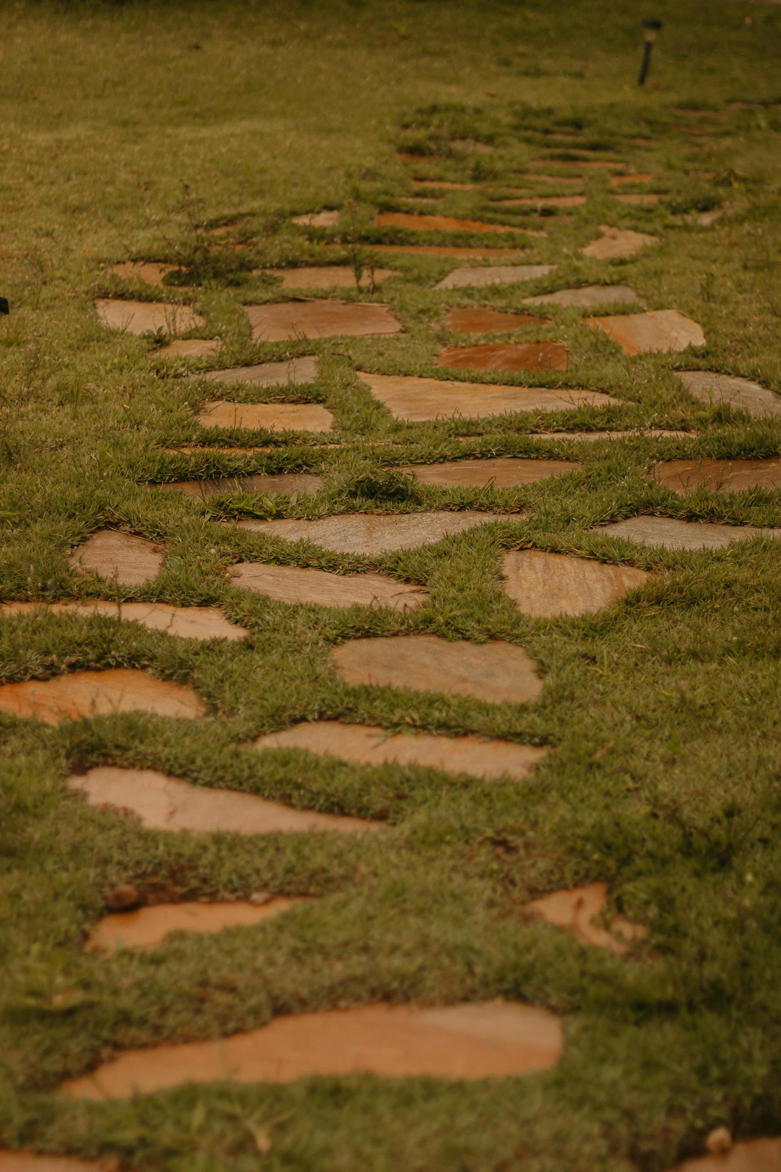 Flagstone stepping-stone path set into trimmed grass with even gait spacing.